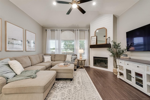 5536 Green Hollow Ln, The Colony, TX 75056 - living room featuring a ceiling fan, dark wood-style flooring, a large fireplace, and lofted ceiling