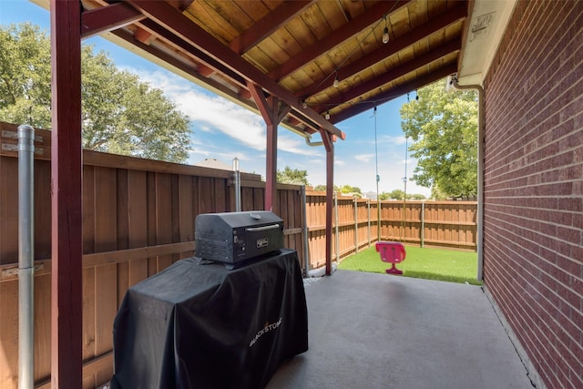 5536 Green Hollow Ln, The Colony, TX 75056 - fenced backyard with a grill and a patio