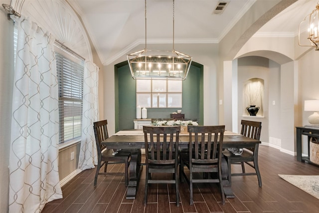 5536 Green Hollow Ln, The Colony, TX 75056 - dining area with dark wood-type flooring, baseboards, a chandelier, arched walkways, and crown molding