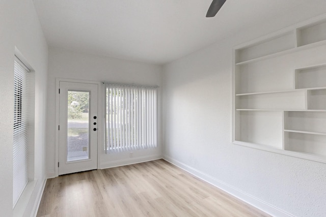 1426 S Beckley Ave, Dallas, TX 75224 - unfurnished room featuring wood finished floors, baseboards, ceiling fan, and built in features