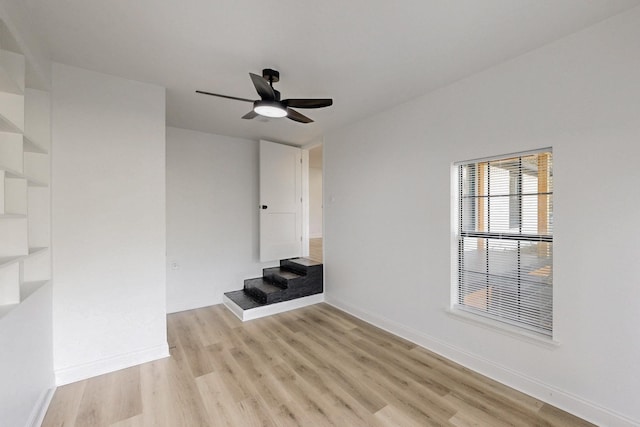 1426 S Beckley Ave, Dallas, TX 75224 - unfurnished living room with light wood-type flooring, a ceiling fan, and baseboards