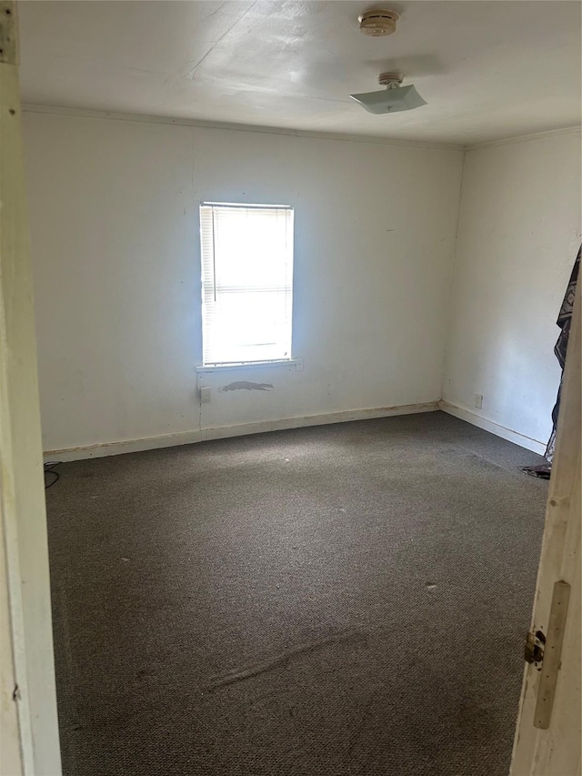 1413 E 8th Ave, Corsicana, TX 75110 - carpeted empty room featuring a smoke detector and baseboards
