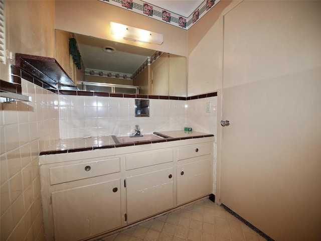 1431 Brazos St, Graham, TX 76450 - full bathroom featuring vanity, tile patterned flooring, and decorative backsplash