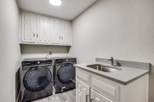 15820 Meadow Vista Dr, Dallas, TX 75248 - laundry area with washing machine and dryer, cabinet space, light wood finished floors, and a textured wall