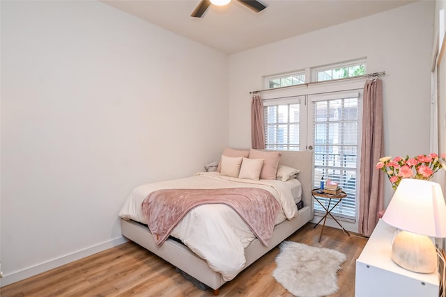 3311 Blackburn St Unit 115, Dallas, TX 75204 - bedroom with light wood finished floors, access to outside, ceiling fan, and baseboards