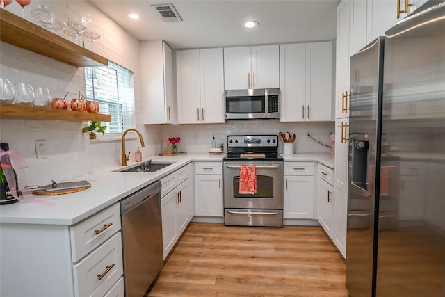 3311 Blackburn St Unit 115, Dallas, TX 75204 - kitchen with appliances with stainless steel finishes, a sink, white cabinetry, open shelves, and recessed lighting