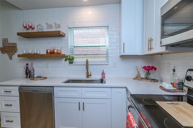 3311 Blackburn St Unit 115, Dallas, TX 75204 - kitchen with stainless steel appliances, a sink, decorative backsplash, light stone countertops, and white cabinets