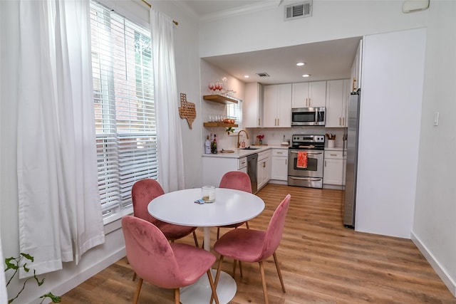 3311 Blackburn St Unit 115, Dallas, TX 75204 - dining space with plenty of natural light, light wood-style flooring, crown molding, recessed lighting, and baseboards