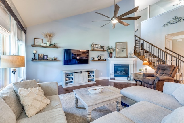 1386 Caspian Dr, Roanoke, TX 76262 - living room featuring ceiling fan, a glass covered fireplace, wood finished floors, baseboards, and high vaulted ceiling