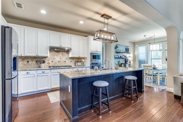 1386 Caspian Dr, Roanoke, TX 76262 - kitchen featuring stainless steel appliances, white cabinetry, dark wood-style flooring, decorative backsplash, and recessed lighting