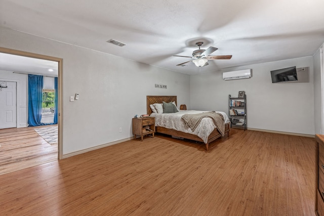 40248 Fm 2481, Hico, TX 76457 - bedroom with a wall mounted AC, light wood-type flooring, baseboards, and ceiling fan