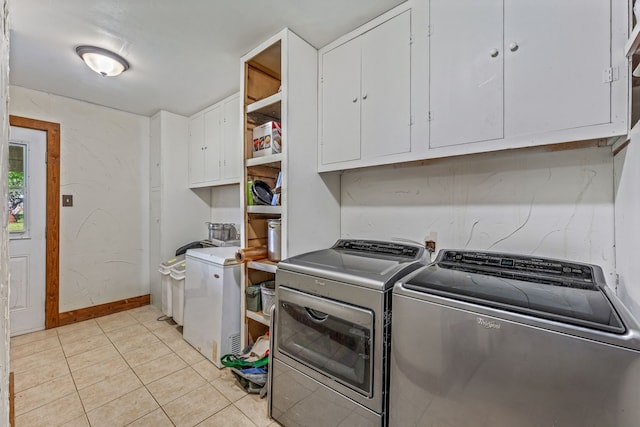 40248 Fm 2481, Hico, TX 76457 - laundry area featuring cabinet space, washing machine and dryer, light tile patterned floors, and baseboards