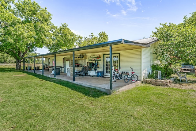 40248 Fm 2481, Hico, TX 76457 - rear view of property featuring a lawn, cooling unit, and metal roof