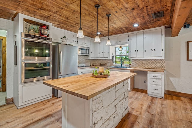 40248 Fm 2481, Hico, TX 76457 - kitchen featuring wooden ceiling, appliances with stainless steel finishes, light wood-style floors, butcher block counters, and white cabinetry