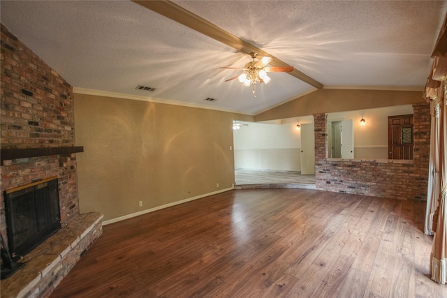 107 Clover Dr, Gun Barrel City, TX 75156 - unfurnished living room featuring a brick fireplace, a ceiling fan, hardwood / wood-style flooring, a textured ceiling, and baseboards