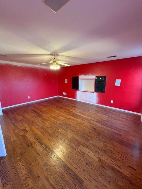 5421 Palace Dr, Richardson, TX 75082 - empty room with wood finished floors, a ceiling fan, and baseboards