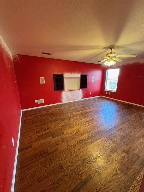 5421 Palace Dr, Richardson, TX 75082 - empty room with wood finished floors, ceiling fan, and baseboards