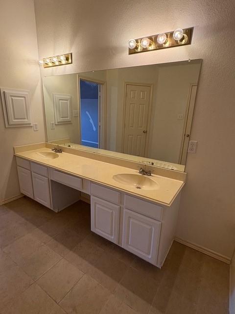 5421 Palace Dr, Richardson, TX 75082 - full bathroom featuring double vanity, baseboards, and tile patterned floors