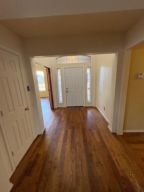 5421 Palace Dr, Richardson, TX 75082 - entryway featuring baseboards and dark wood-style floors