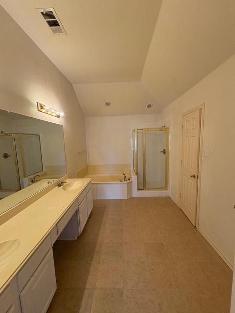 5421 Palace Dr, Richardson, TX 75082 - bathroom with vaulted ceiling, double vanity, a bath, and a shower stall