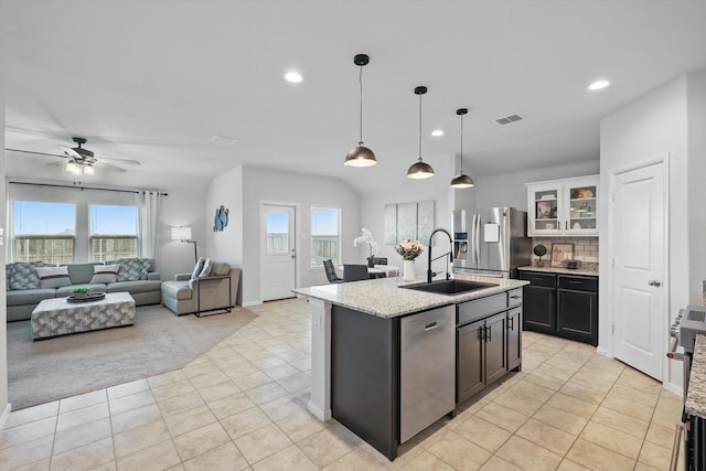 3800 Canyon Verde Ln, Denton, TX 76226 - kitchen with stainless steel appliances, a sink, light tile patterned floors, recessed lighting, and decorative light fixtures