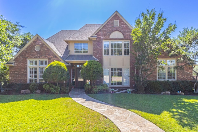 2111 Menton Pl, Carrollton, TX 75006 - traditional home featuring a front lawn, a shingled roof, and brick siding