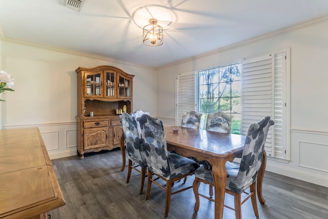 2111 Menton Pl, Carrollton, TX 75006 - dining room with crown molding, dark wood-style flooring, a wainscoted wall, and a decorative wall