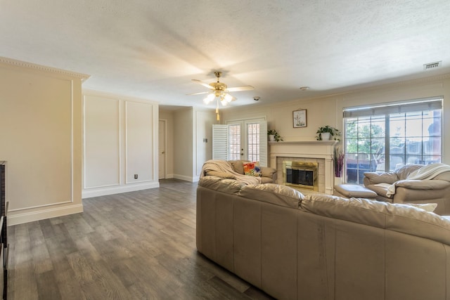 2111 Menton Pl, Carrollton, TX 75006 - living room with a glass covered fireplace, ceiling fan, dark wood-style floors, a decorative wall, and baseboards