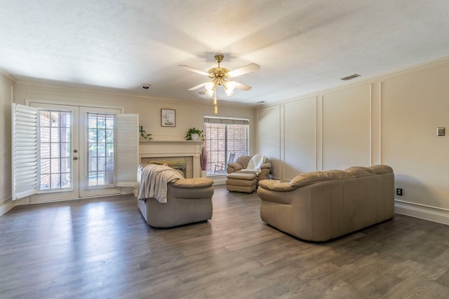 2111 Menton Pl, Carrollton, TX 75006 - living room featuring french doors, ornamental molding, a ceiling fan, a decorative wall, and wood finished floors