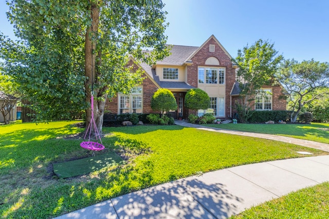 2111 Menton Pl, Carrollton, TX 75006 - traditional-style house with a front lawn and brick siding