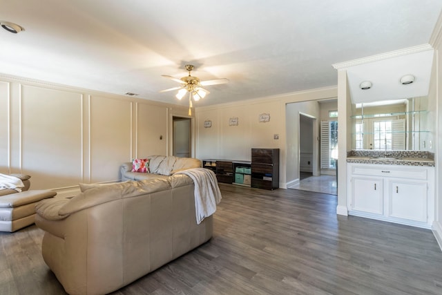 2111 Menton Pl, Carrollton, TX 75006 - living area with crown molding, a ceiling fan, wood finished floors, and a decorative wall