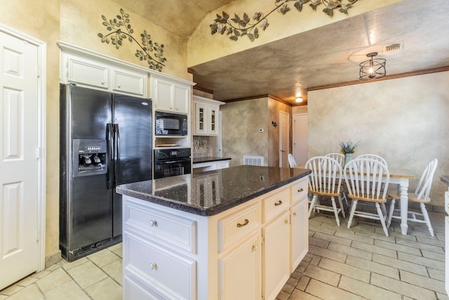 2111 Menton Pl, Carrollton, TX 75006 - kitchen with black appliances, white cabinets, a kitchen island, dark stone countertops, and lofted ceiling