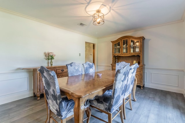 2111 Menton Pl, Carrollton, TX 75006 - dining space with a decorative wall, wood finished floors, crown molding, and wainscoting