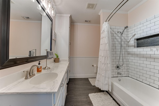 430 Hornik Rd, Ennis, TX 75119 - full bathroom featuring vanity, crown molding, shower / tub combo with curtain, wood finished floors, and a wainscoted wall