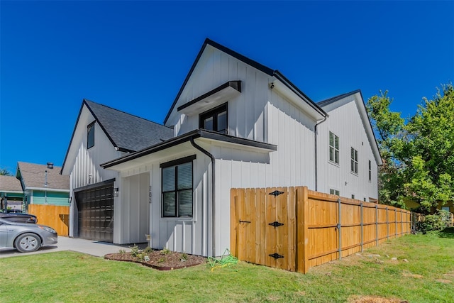 702 Graham Ave, Dallas, TX 75223 - view of side of home with board and batten siding and roof with shingles