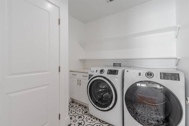 702 Graham Ave, Dallas, TX 75223 - laundry area featuring separate washer and dryer, cabinet space, and light tile patterned floors