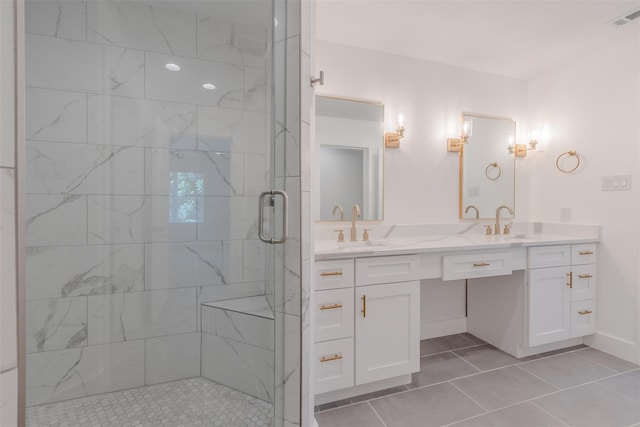 702 Graham Ave, Dallas, TX 75223 - bathroom with a marble finish shower, double vanity, tile patterned flooring, and baseboards