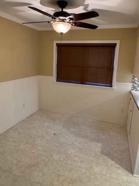 401 Locust St, Shreveport, LA 71105 - unfurnished room featuring a ceiling fan, ornamental molding, and wainscoting