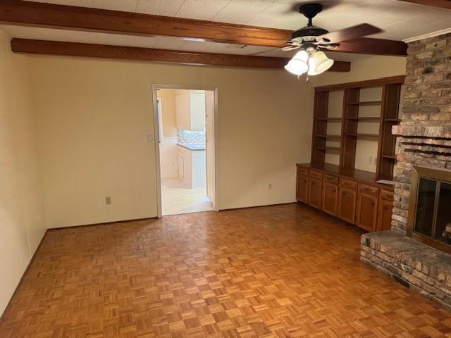 401 Locust St, Shreveport, LA 71105 - unfurnished living room featuring a fireplace, ceiling fan, and beam ceiling