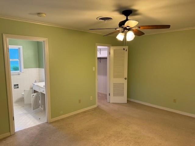 401 Locust St, Shreveport, LA 71105 - unfurnished bedroom with carpet, crown molding, a spacious closet, ensuite bath, and baseboards