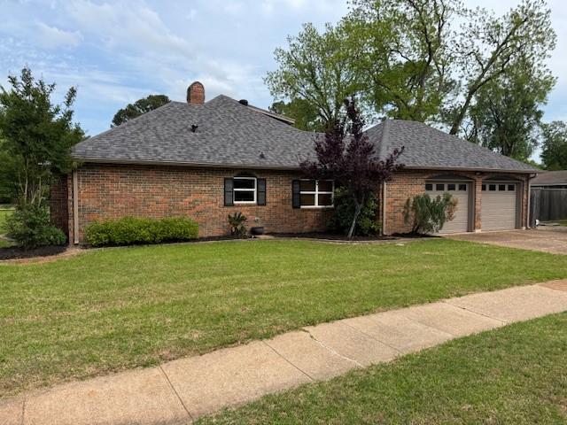 401 Locust St, Shreveport, LA 71105 - view of front of home featuring an attached garage, a front yard, brick siding, roof with shingles, and concrete driveway