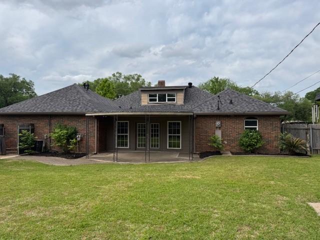 401 Locust St, Shreveport, LA 71105 - back of property with a patio area, brick siding, french doors, roof with shingles, and a chimney
