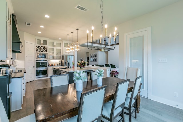 2104 Palafox Dr, Waco, TX 76655 - dining space featuring dark wood finished floors, a chandelier, recessed lighting, and baseboards