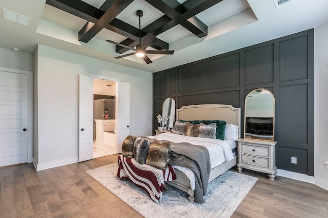 2104 Palafox Dr, Waco, TX 76655 - bedroom with coffered ceiling, wood finished floors, beamed ceiling, baseboards, and connected bathroom