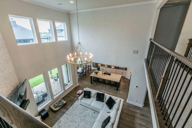 2104 Palafox Dr, Waco, TX 76655 - living room featuring wood finished floors, a chandelier, ornamental molding, baseboards, and recessed lighting