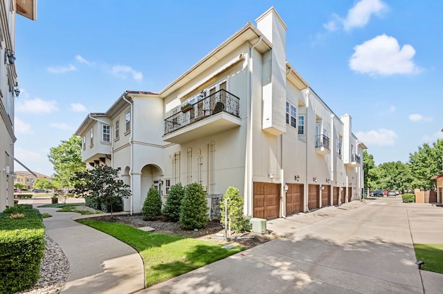33 Main St Unit 220, Colleyville, TX 76034 - view of building exterior with a garage, driveway, and a residential view