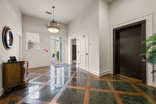 33 Main St Unit 220, Colleyville, TX 76034 - foyer entrance featuring inlaid floor details, baseboards, and a towering ceiling