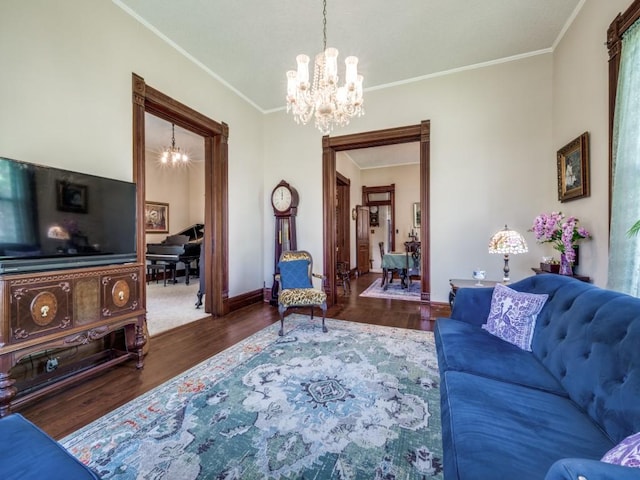306 E Tarrant St, Bowie, TX 76230 - living room featuring a chandelier, ornamental molding, wood finished floors, and baseboards