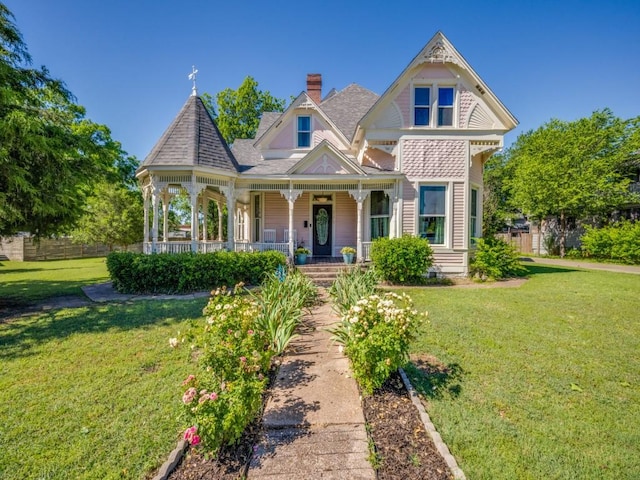 306 E Tarrant St, Bowie, TX 76230 - victorian-style house with covered porch and a chimney