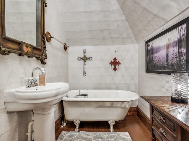 306 E Tarrant St, Bowie, TX 76230 - full bathroom featuring wood finished floors and a soaking tub
